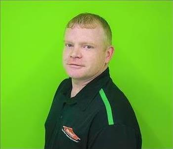 Photo of man in front of Green Background